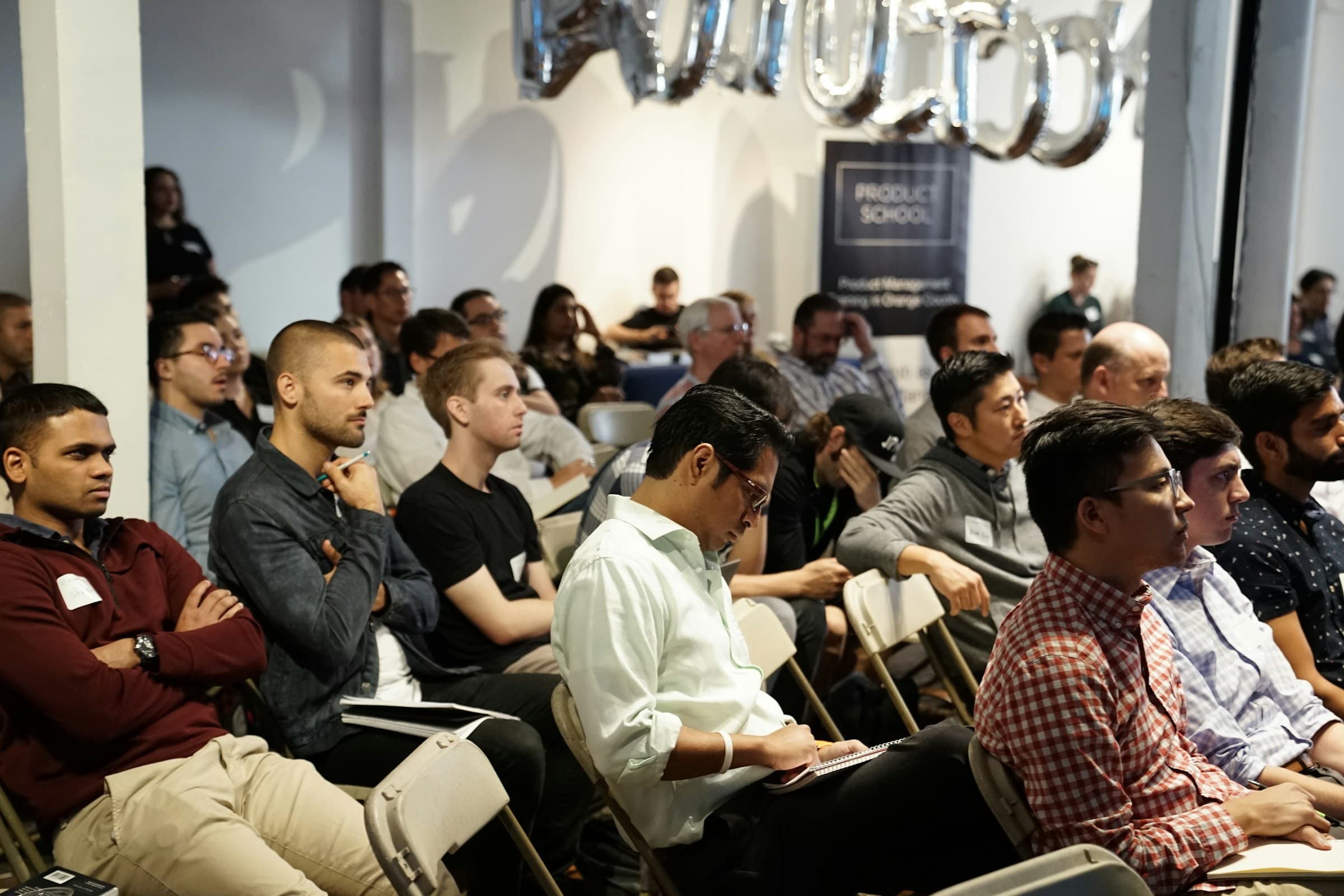 Visitors listening to a presentation at a busy industry event